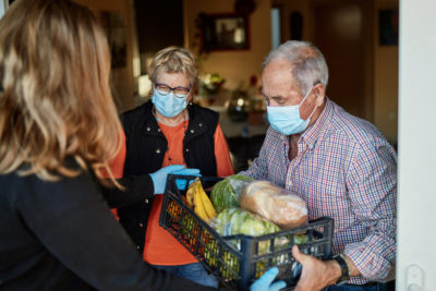 couple in masks receives food